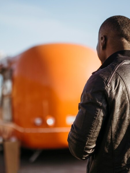 mid-shot-man-walking-towards-food-truck_23-2148757255