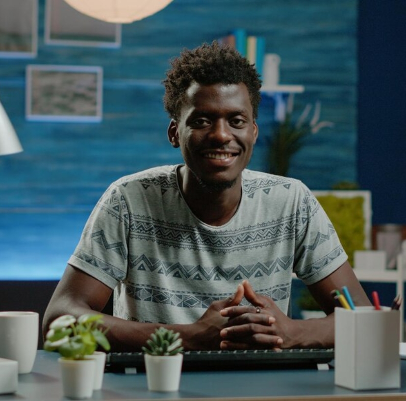 portrait-entrepreneur-prepared-remote-work-computer-desk-corporate-employee-looking-camera-smiling-working-from-home-using-technology-business-worker-workspace_482257-31443